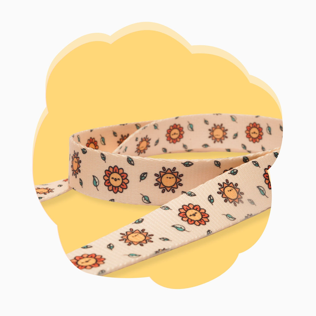 Beige floral dog leash on yellow background – stylish and durable pet leash.